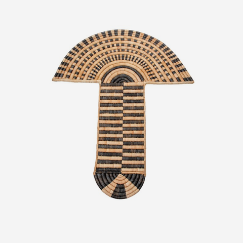 A hand-woven decorative wall hook shaped like a mushroom, featuring a natural tan base with black and brown striped patterns, shown against a plain light gray background.