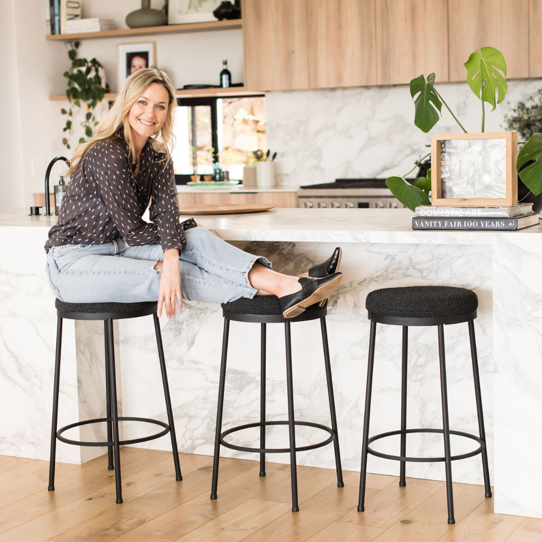 Kerry McGregor sitting on locally designed kitchen stools.