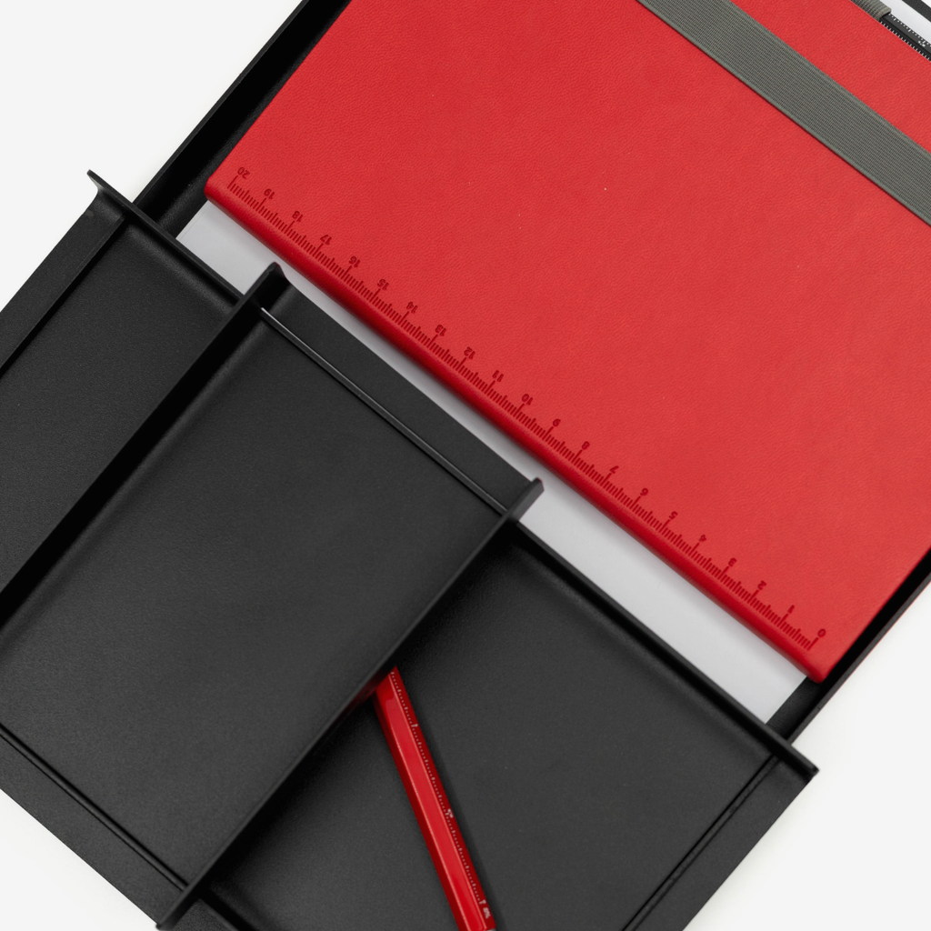 Red and black stationery items including a ruler, pen, and folders on a white background